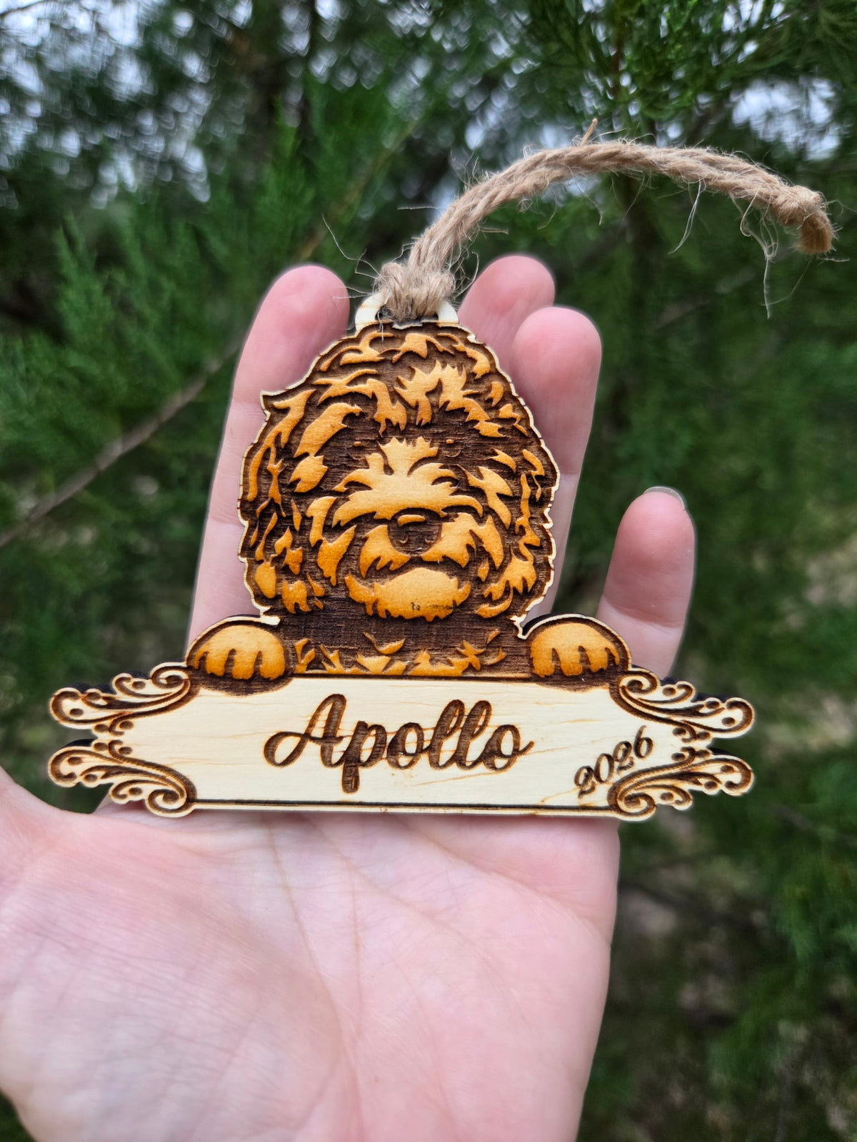 Doodle dog plaque ornament held in an open hand to show its size
