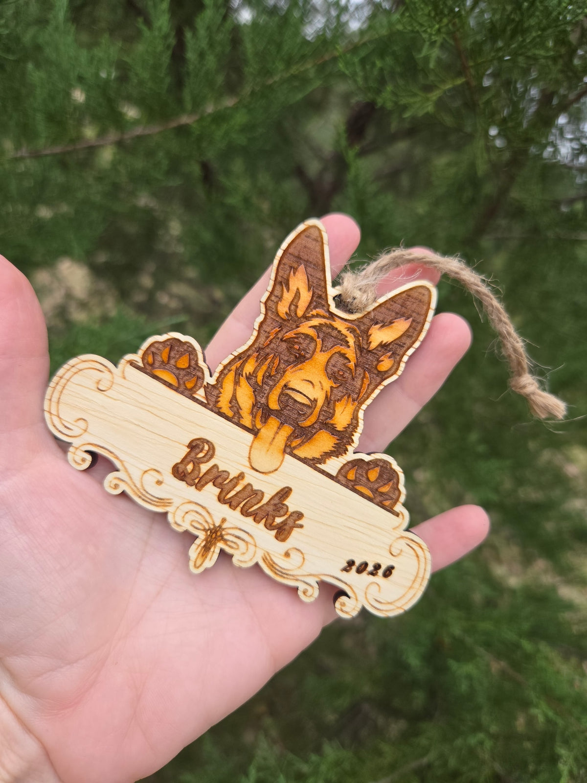 German Shepherd plaque ornament held in an open hand to show its size