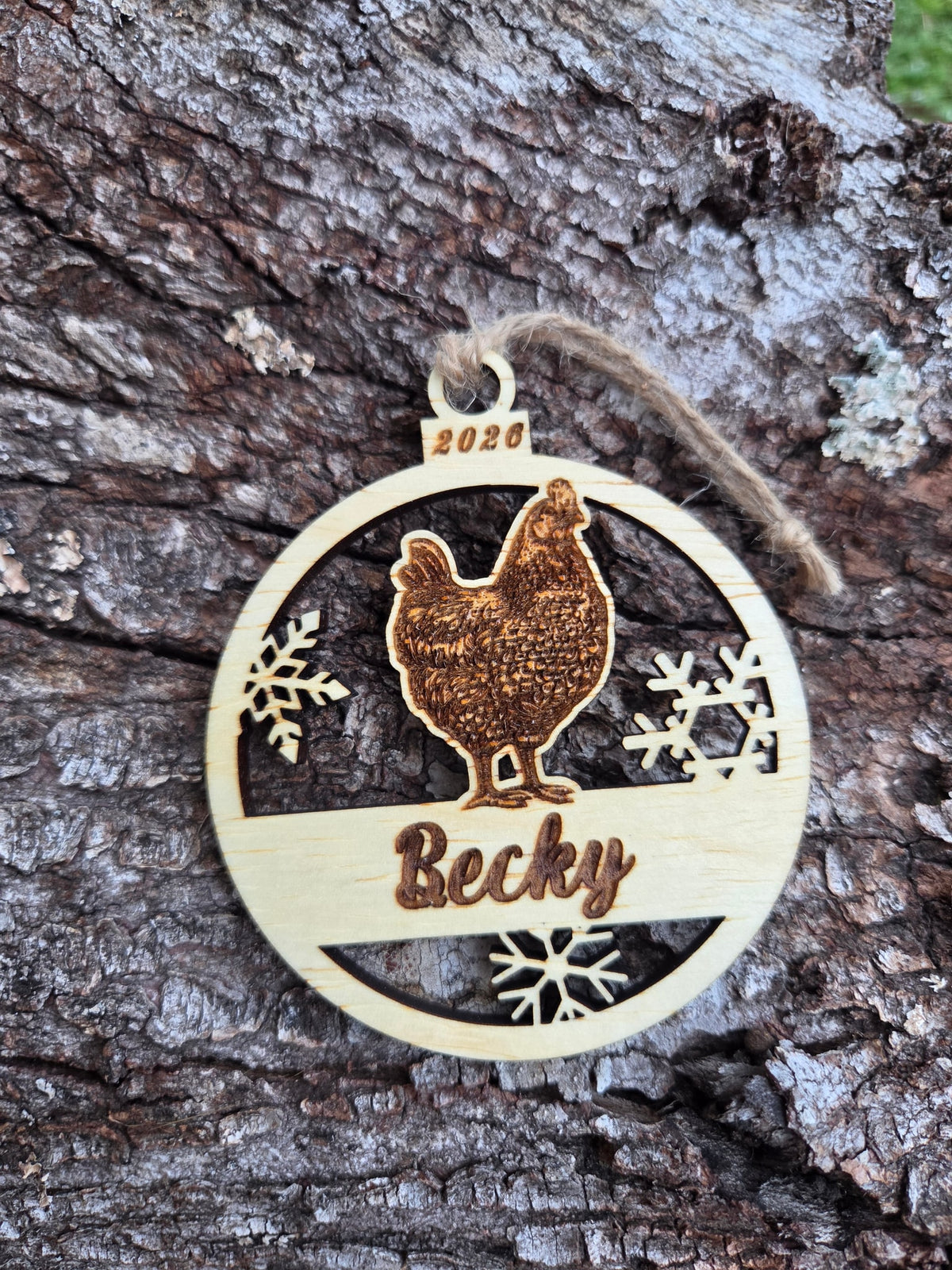 Wooden hen and snowflakes ornament, front layer with a sample name and year engraved, shown without its colored back