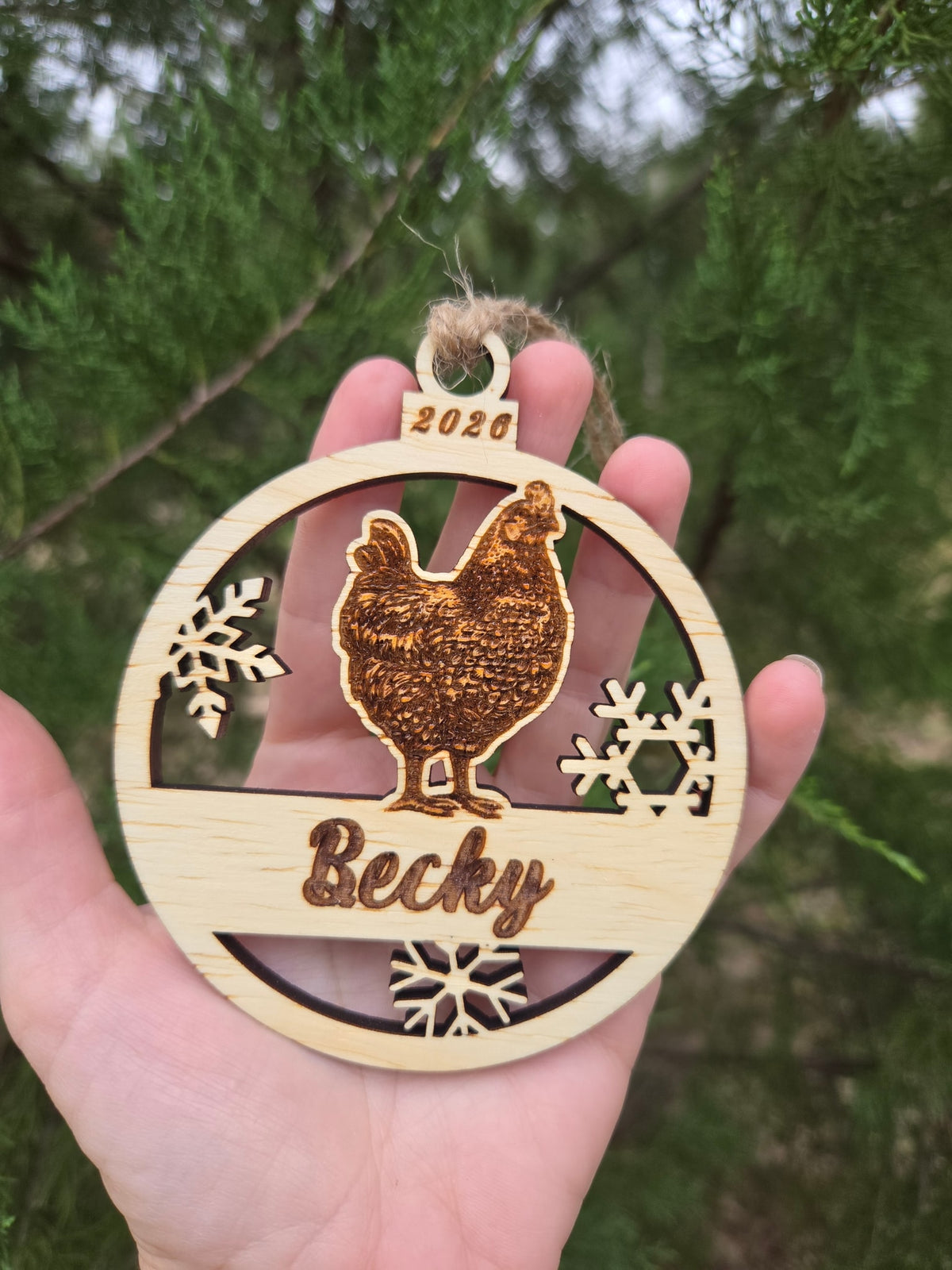 Hen and snowflakes ornament held in an open hand to show its size