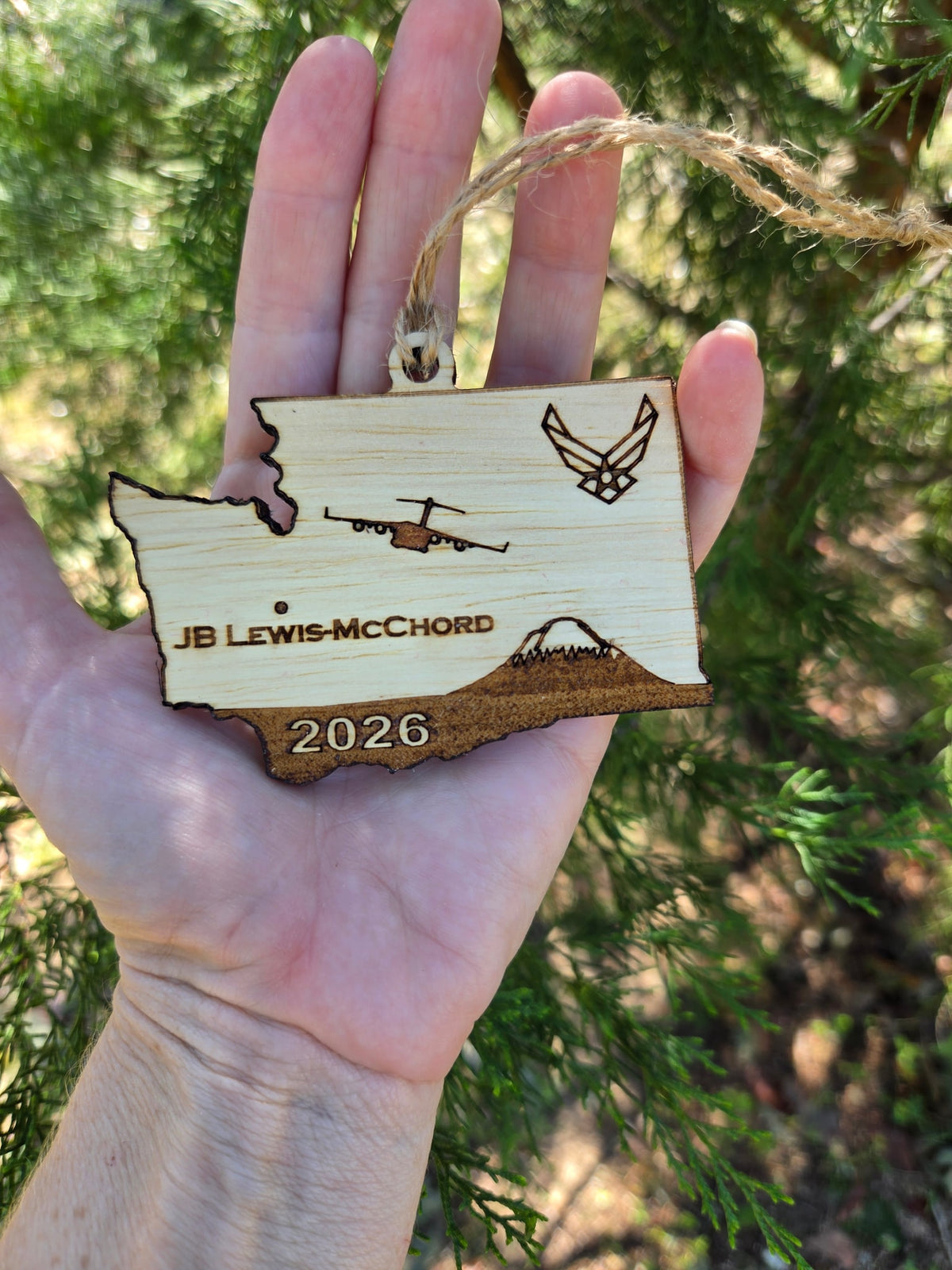 JB Lewis-McChord Washington ornament held in an open hand to show its size