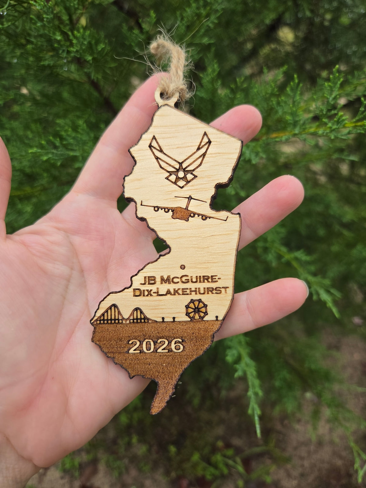JB McGuire-Dix-Lakehurst New Jersey ornament held in an open hand to show its size