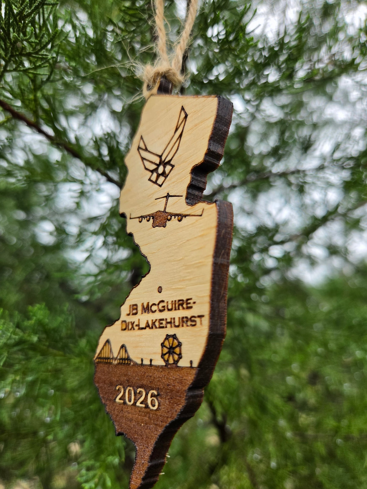 Side view of the JB McGuire-Dix-Lakehurst ornament showing the thickness of the wood and its dark cut edge