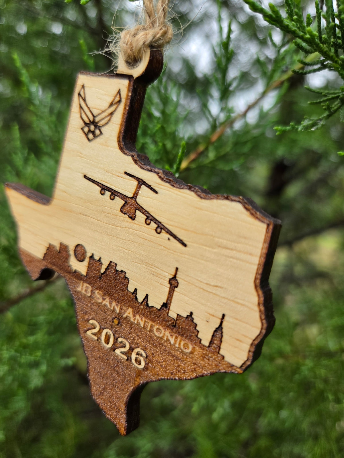 Side view of the JB San Antonio ornament showing the thickness of the wood and its dark cut edge