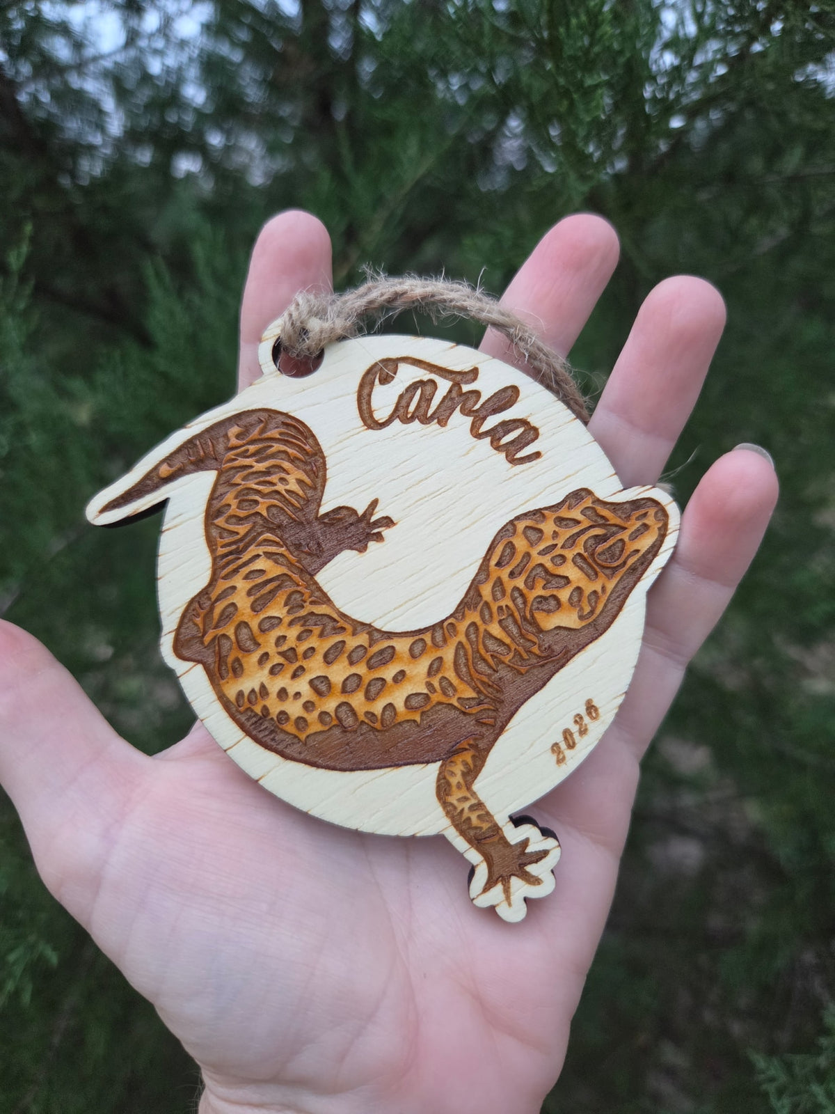 Leopard gecko ornament held in an open hand to show its size