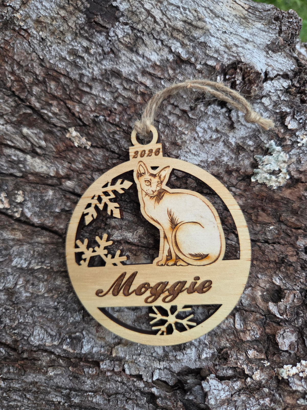 Wooden sitting Sphynx cat ornament, front layer with a sample name and year engraved, shown without its colored back