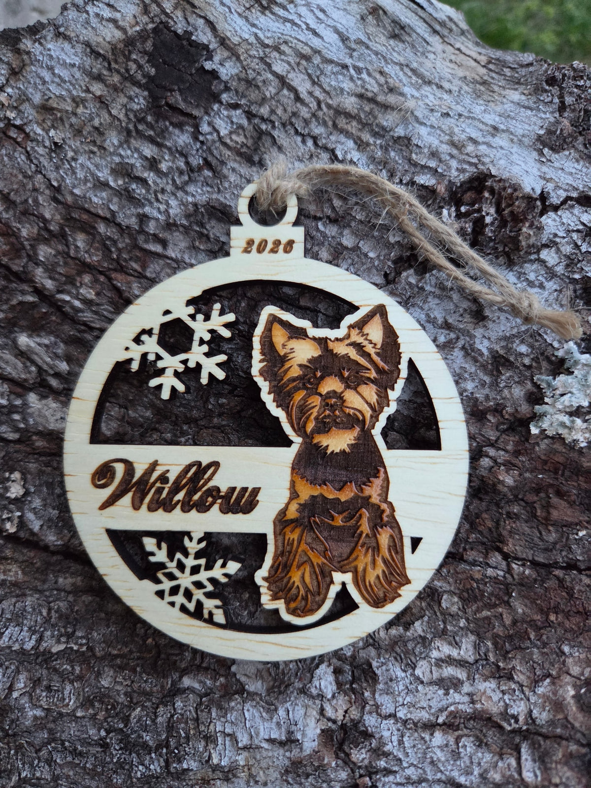 Wooden sitting Yorkie and snowflakes ornament, front with a sample name and year engraved, without its colored back