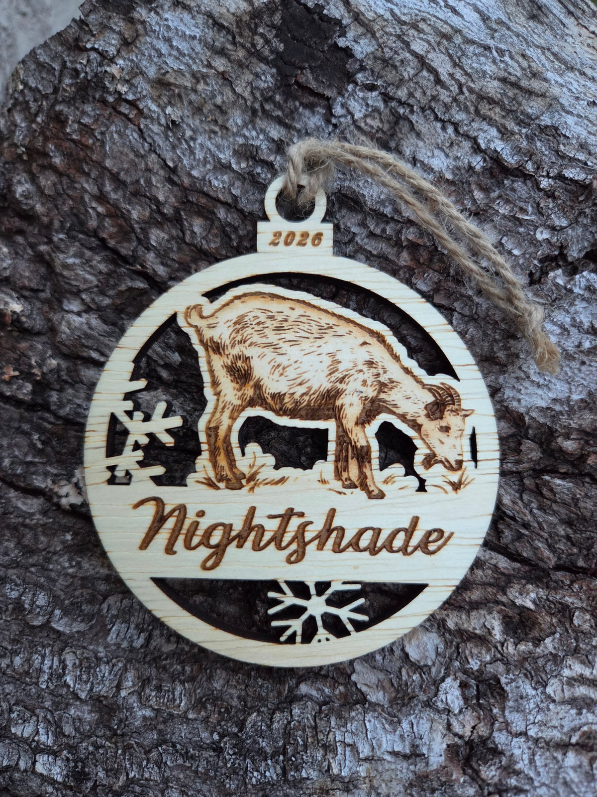 Wooden standing goat and snowflakes ornament, front with a sample name and year engraved, without its colored back