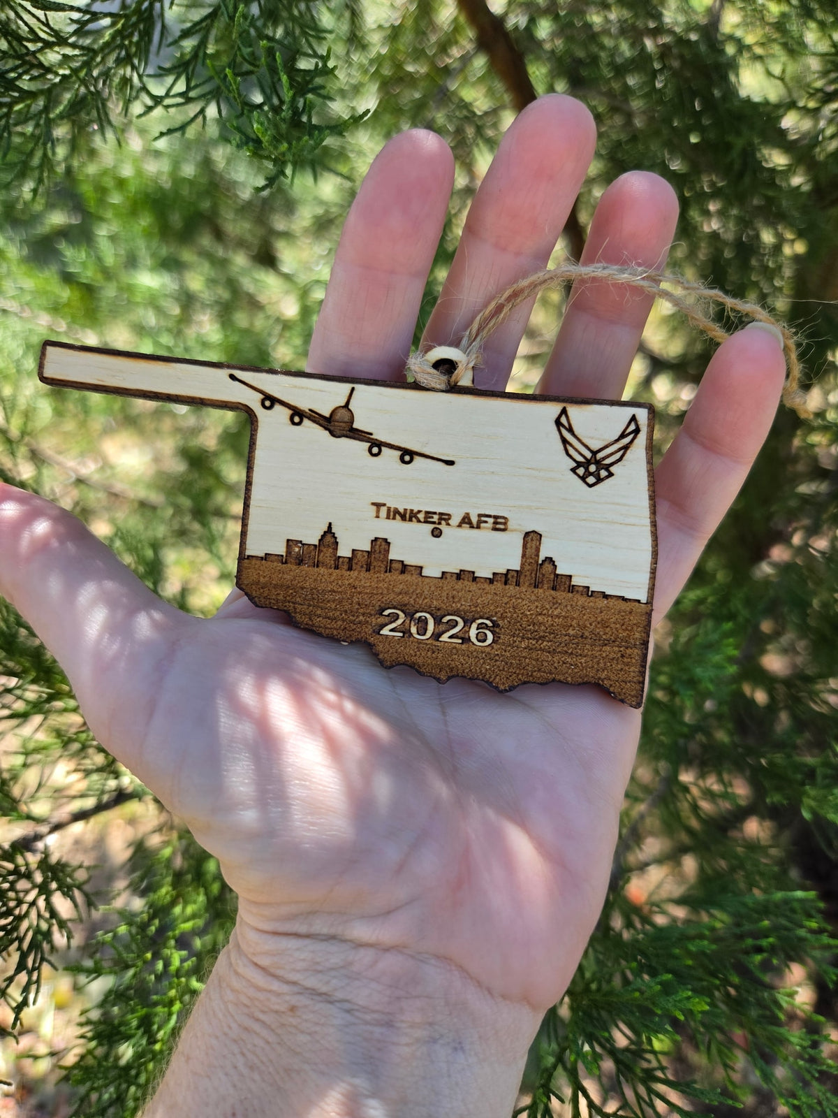 Tinker AFB Oklahoma ornament held in an open hand to show its size