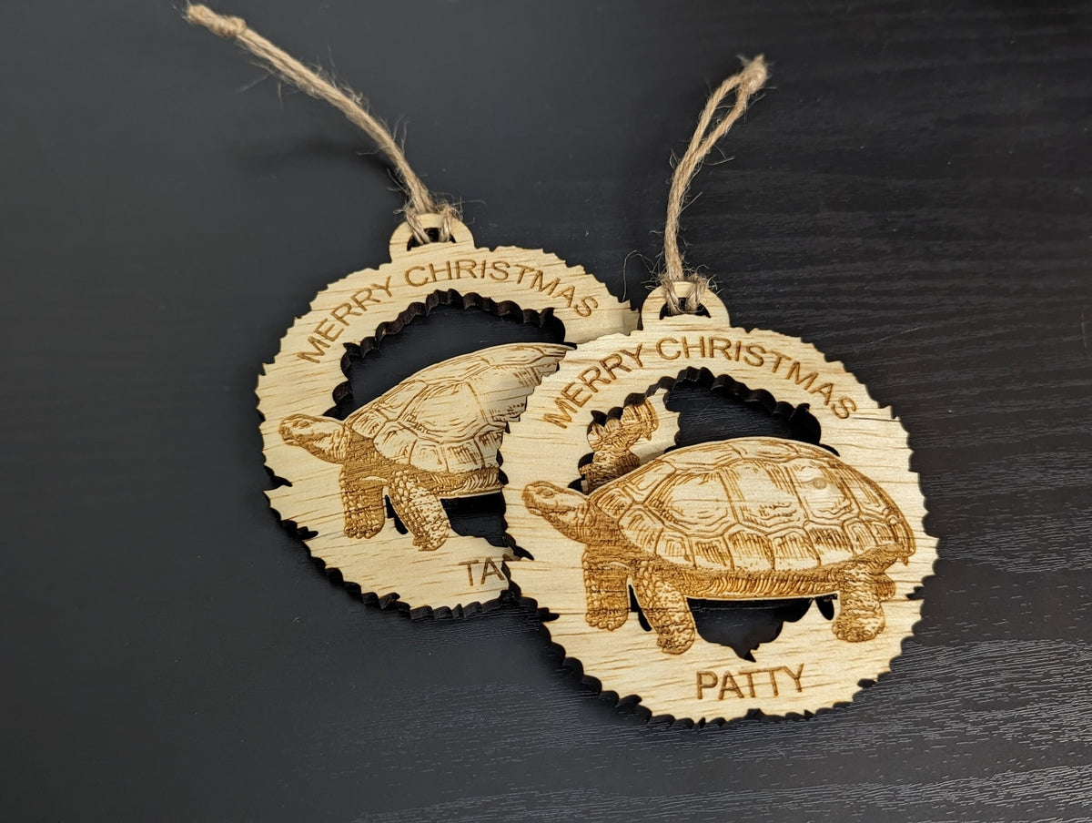 Two tortoise wreath ornaments with Merry Christmas across the top, one engraved Patty.