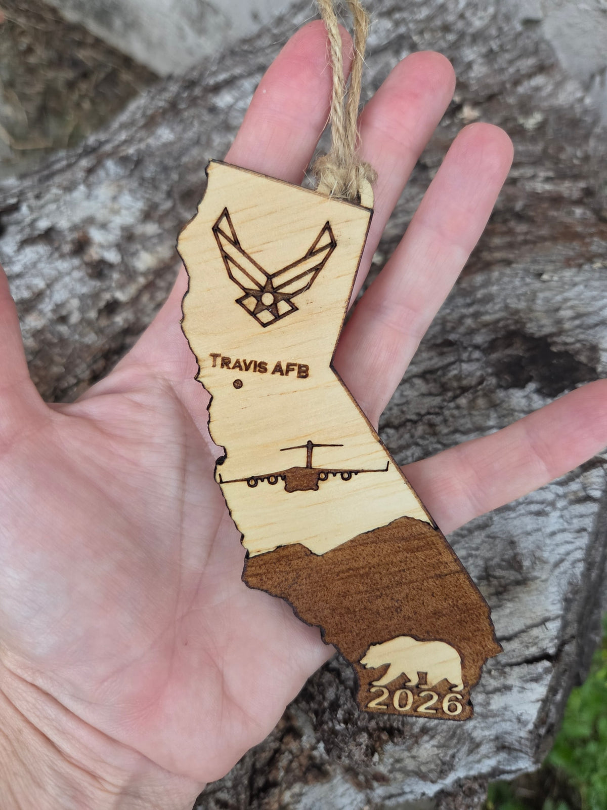 Travis AFB California ornament held in an open hand to show its size