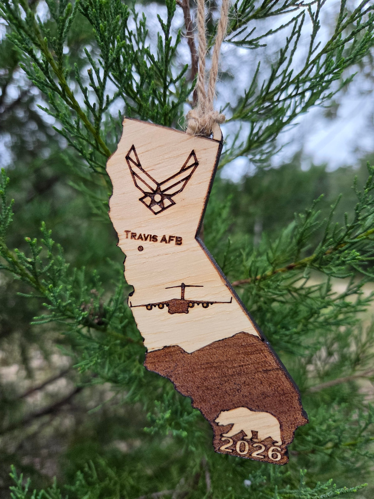 Travis AFB ornament on an evergreen tree, with the California bear and the year at the bottom