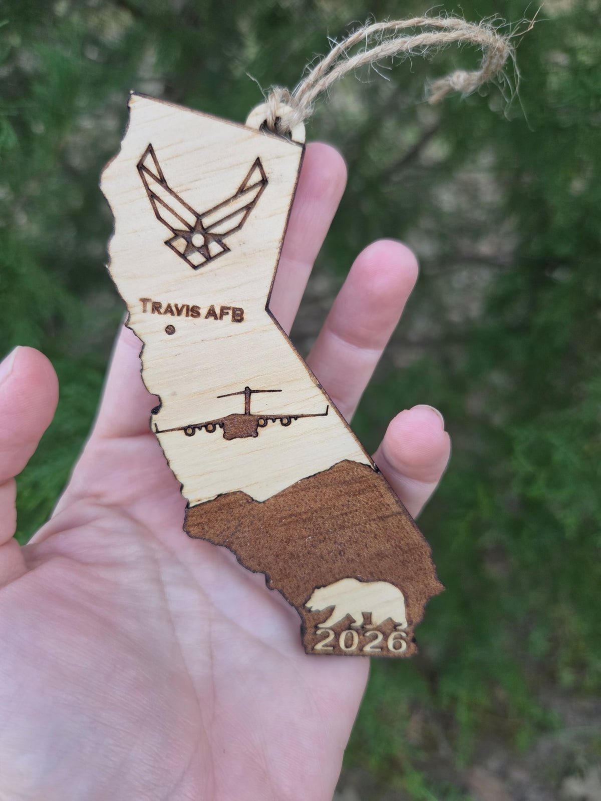Travis AFB C-17 California ornament held in an open hand