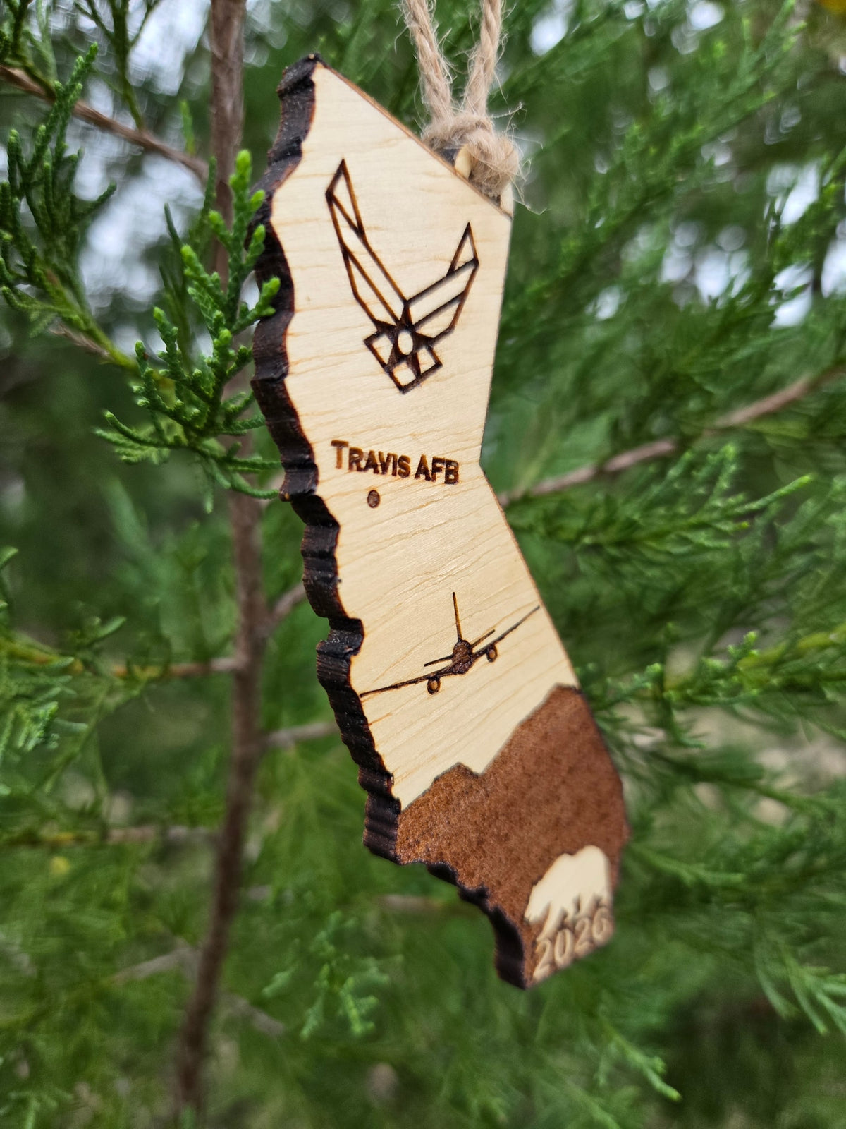 Angled view of the Travis AFB KC-46A ornament showing the thickness of the wood and its dark cut edge