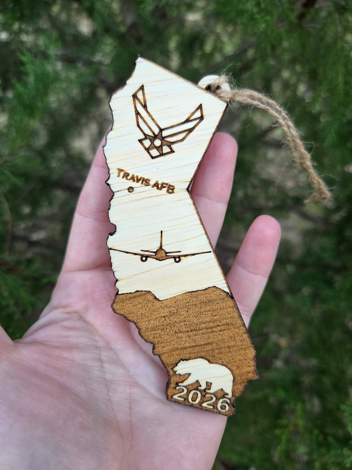 Travis AFB KC-46A California ornament held in an open hand, slightly turned